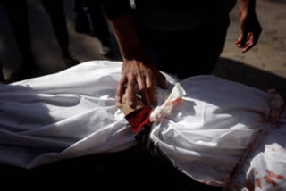 A Palestinian man mourns over the body of a child killed in the Israeli bombardment of the Gaza Strip, at Nasser hospital in Khan Younis, Monday, Jan. 22, 2024.