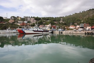 Vessels are docked at the port of Shengjin, northwestern Albania, one of two proposed places to house migrants, on Tuesday, Nov. 7, 2023. Albania's Assembly, or Parliament, votes on Thursday, Feb. 22, 2024, and is expected to approve a deal with Italy under which thousands of migrants rescued at sea by Italian authorities would be sent to Albania while their applications for asylum in Italy are processed. (AP Photo/Armando Babani, File)