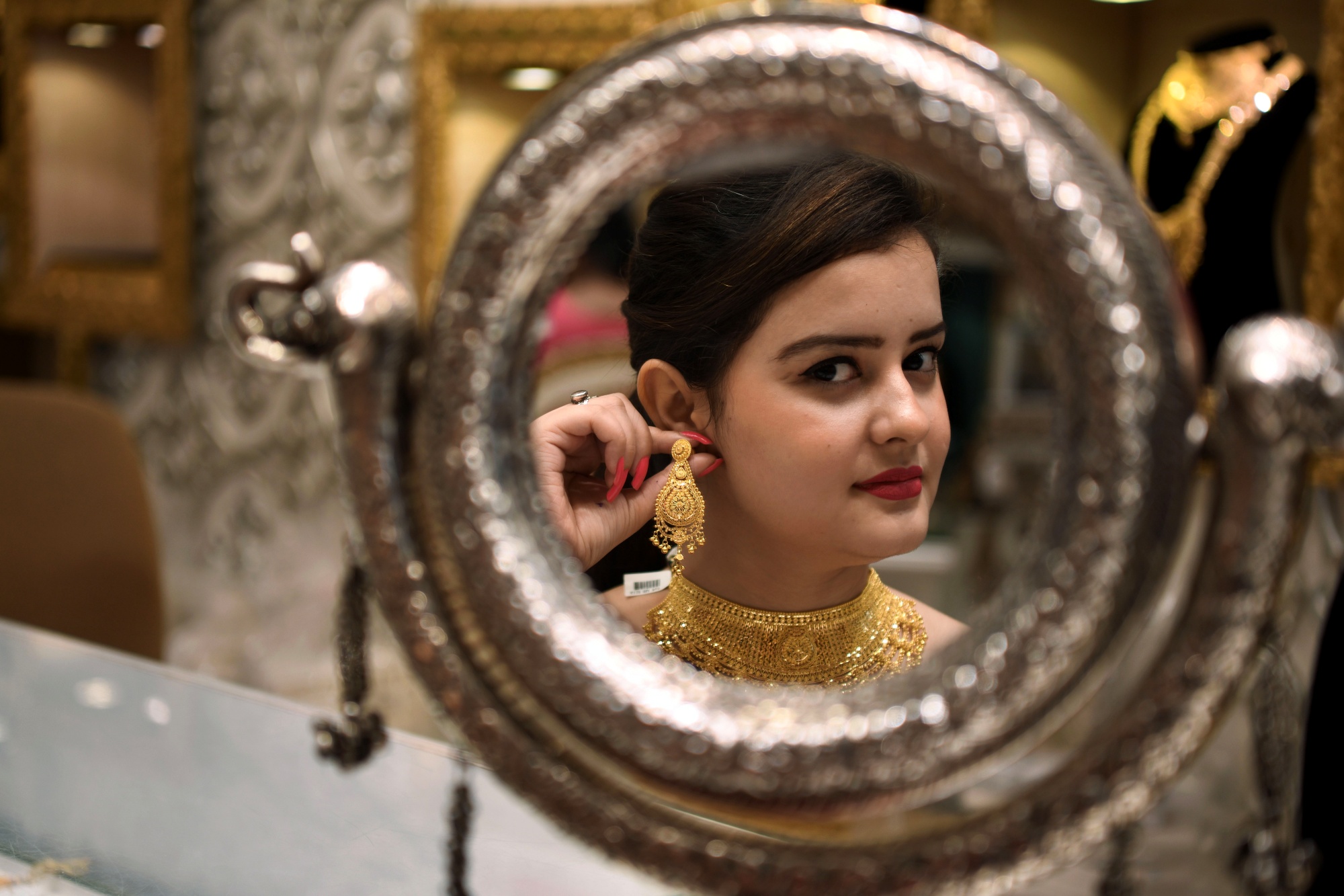 File photo of a woman checking out gold jewellery.