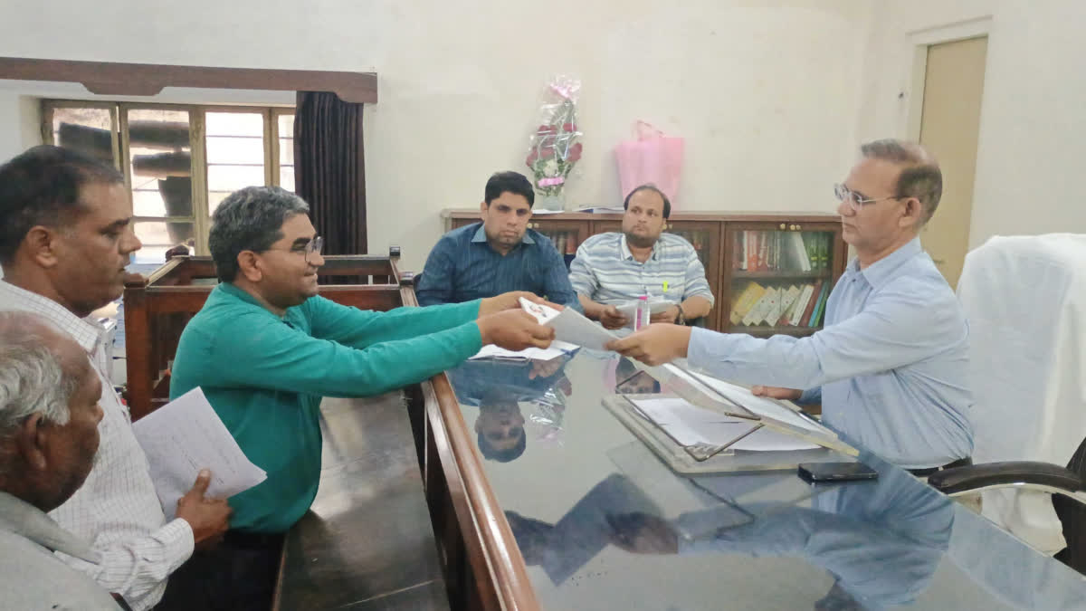 A candidate handing over nomination papers to the District Election Officer in Jaipur