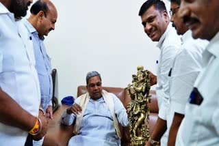 KMF President Bhima Naik presented the Lord Krishna idol to the CM.
