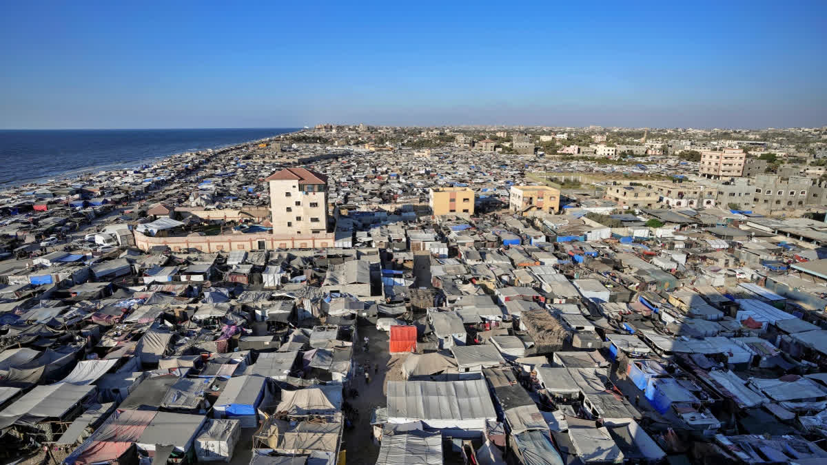 Tents are crammed together as displaced Palestinians camp on the beach, west of Deir al-Balah, Gaza Strip, Tuesday, Aug. 20, 2024.