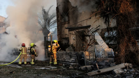 Israeli security and rescue forces work at the site hit by a rocket fired from Lebanon, in Kiryat Bialik, northern Israel, on Sunday