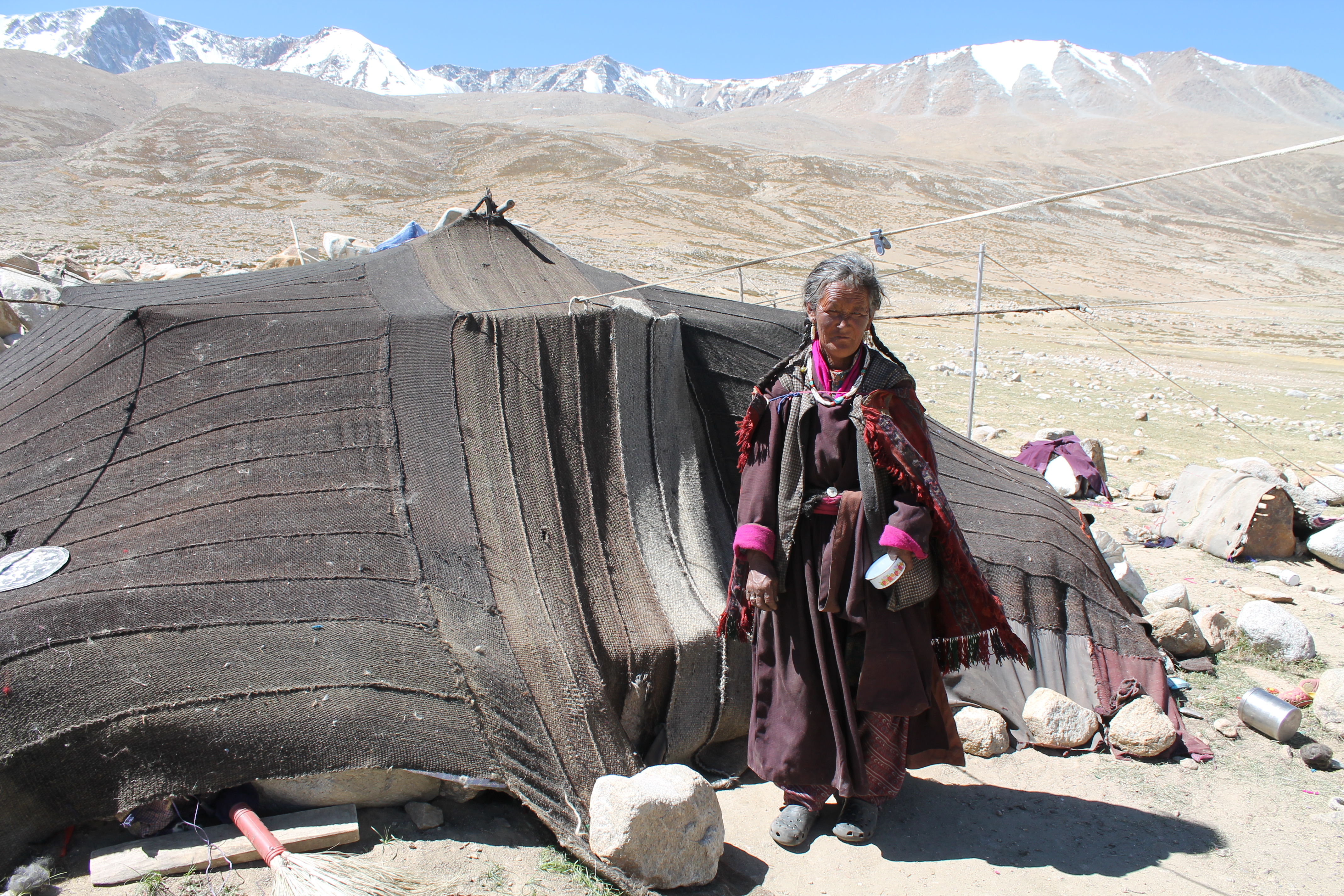 An elderly woman stands by her tent at a border village in Ladakh