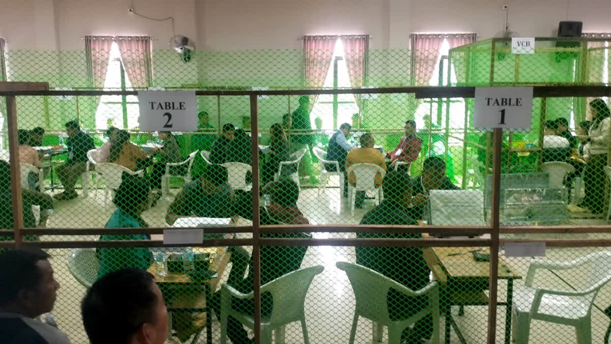 Election officials counting votes at a counting centre