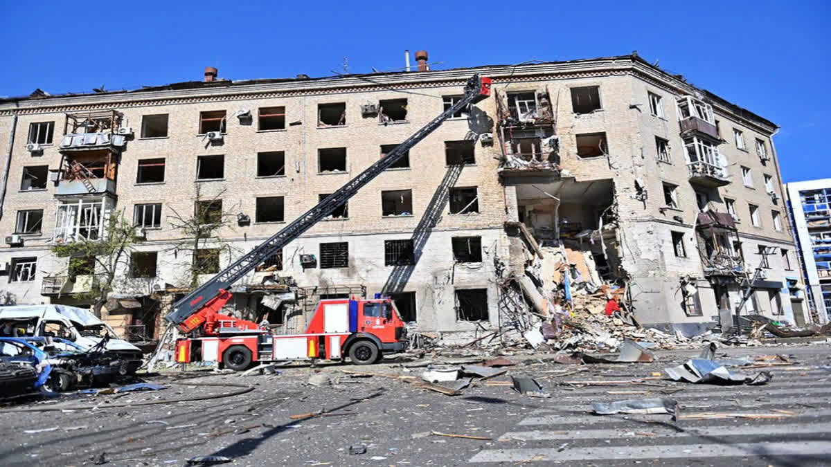 Rrescuers work in a damaged apartment house after it was hit by Russian air bomb killing at least 3 and injuring 23, in Kharkiv, Ukraine, on June 22, 2024.