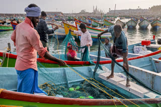 File photo of fishermen fixing their nets