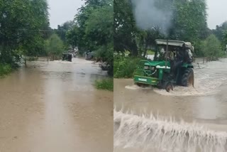 TRACTOR CROSSED OVERFLOWING DRAIN