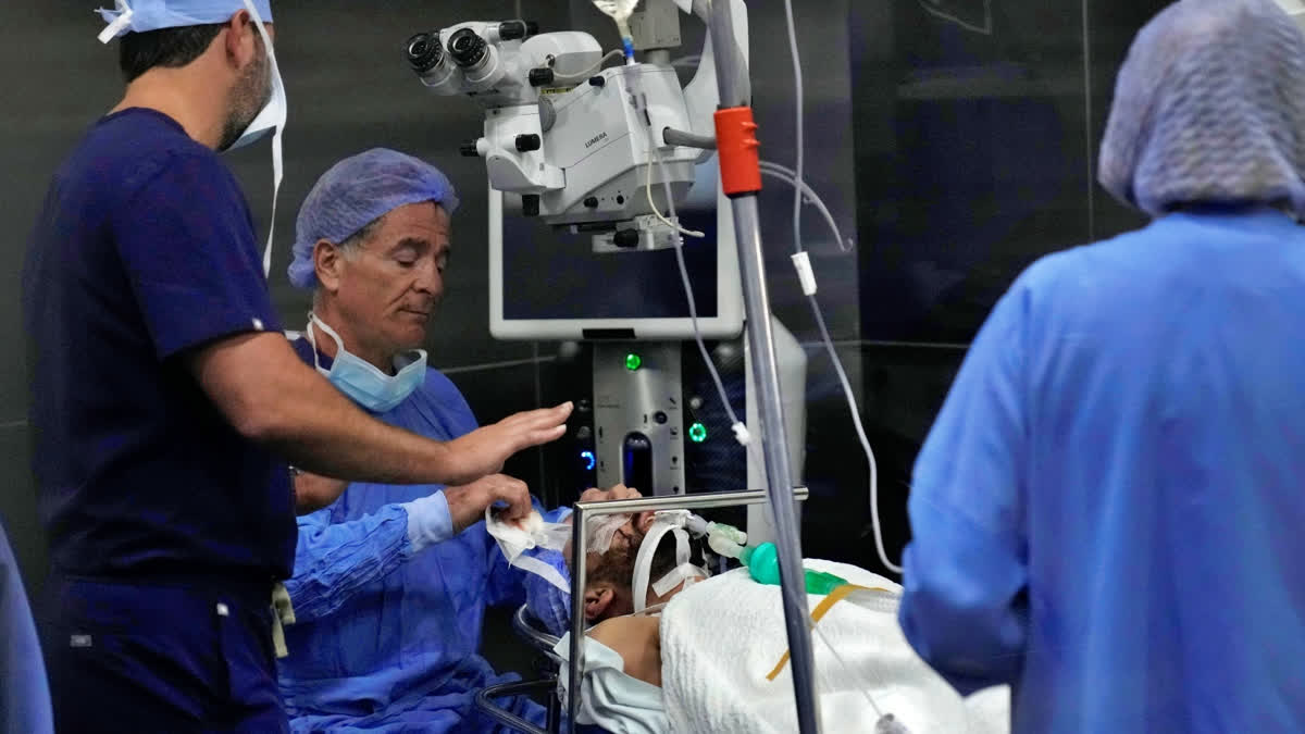 Elias Jaradeh, a legislator and an ophthalmologist, center, who has conducted dozens of operation for victims of this week's attack in Lebanon, makes an eye surgery operation for a man who was injured in the explosion of one of the handheld devices, at the Eye Specialist hospital, in Beirut, Lebanon, Friday, Sept. 20, 2024.