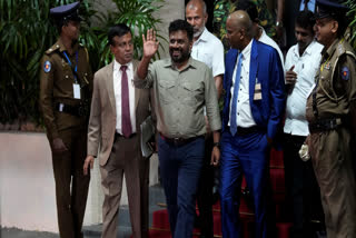 Marxist lawmaker Anura Kumara Dissanayake waves as he departs the election commission office after winning the Sri Lankan presidential election in Colombo, Sri Lanka, Sunday, Sept. 22, 2024.