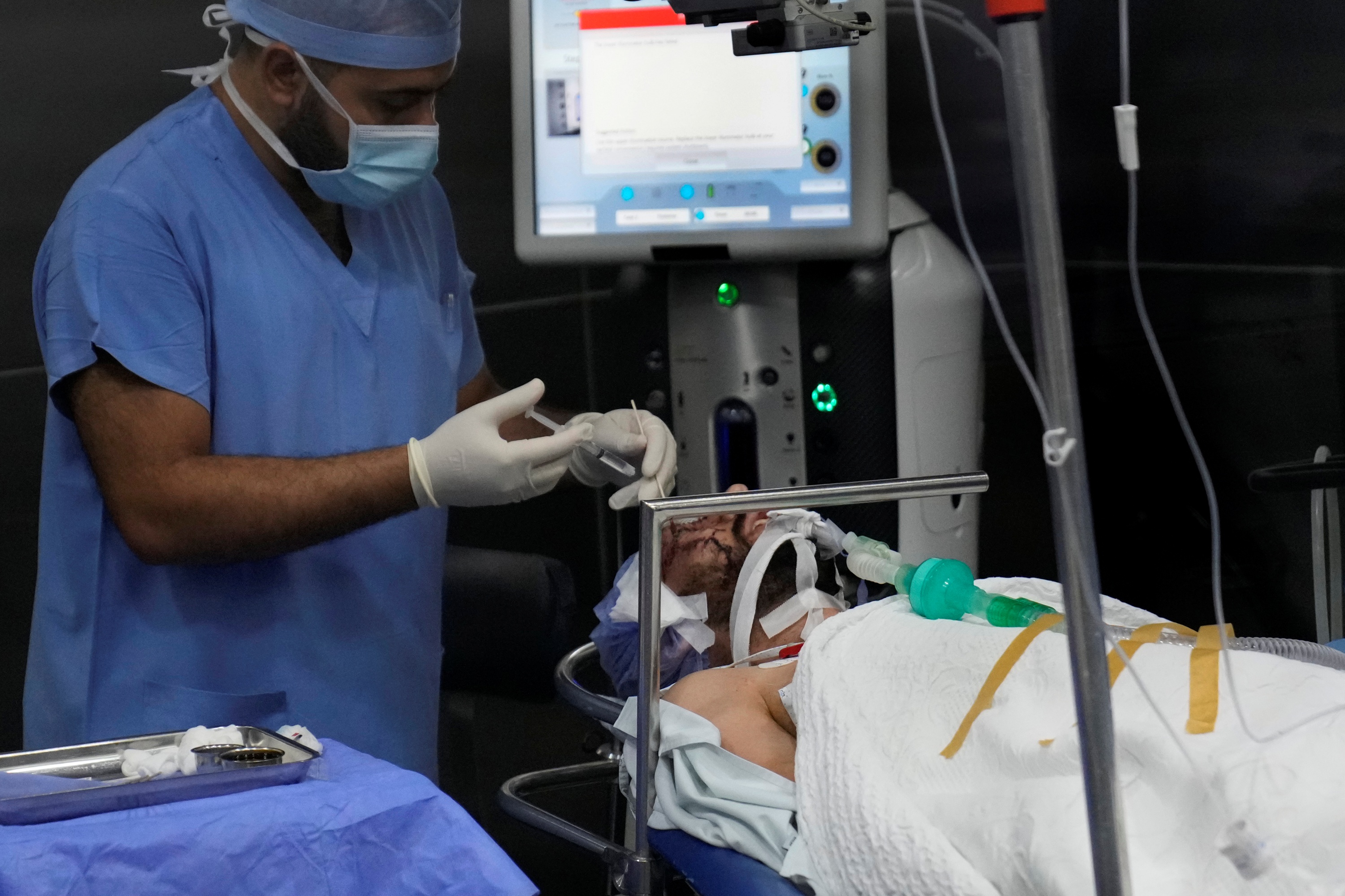 A man who was injured in the explosion of one of the handheld devices, lies inside an operation room ahead of an eye surgery at the Eye Specialist hospital, in Beirut, Lebanon, Friday, Sept. 20, 2024.