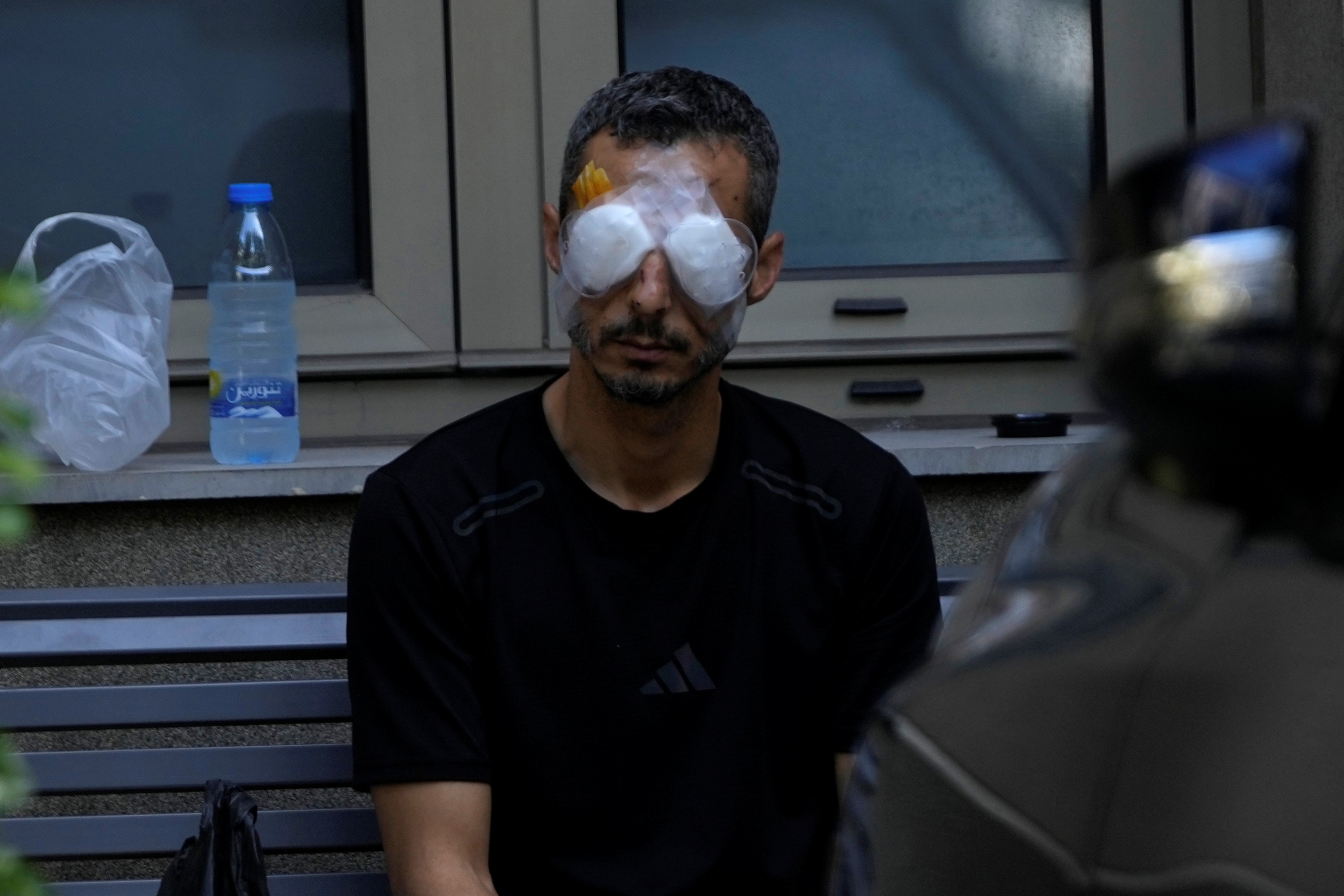 A man who was injured in the explosion of one of the handheld devices, sits outside the Eye Specialist hospital, in Beirut, Lebanon, Friday, Sept. 20, 2024.