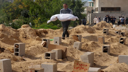 Palestinians bury the bodies of their relatives killed in the Israeli bombardment of the Gaza Strip, at a cemetery in Deir Al-Balah, Gaza, Monday, Oct. 23, 2023. (AP Photo/Hatem Moussa)