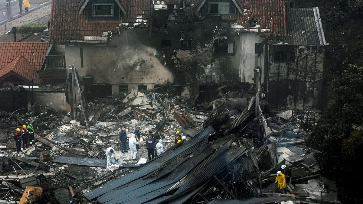 TOPSHOT - Firefighters and other rescue teams work in the site of a plane crash at the city of Gramado, Rio Grande do Sul state, Brazil, on December 22, 2024.