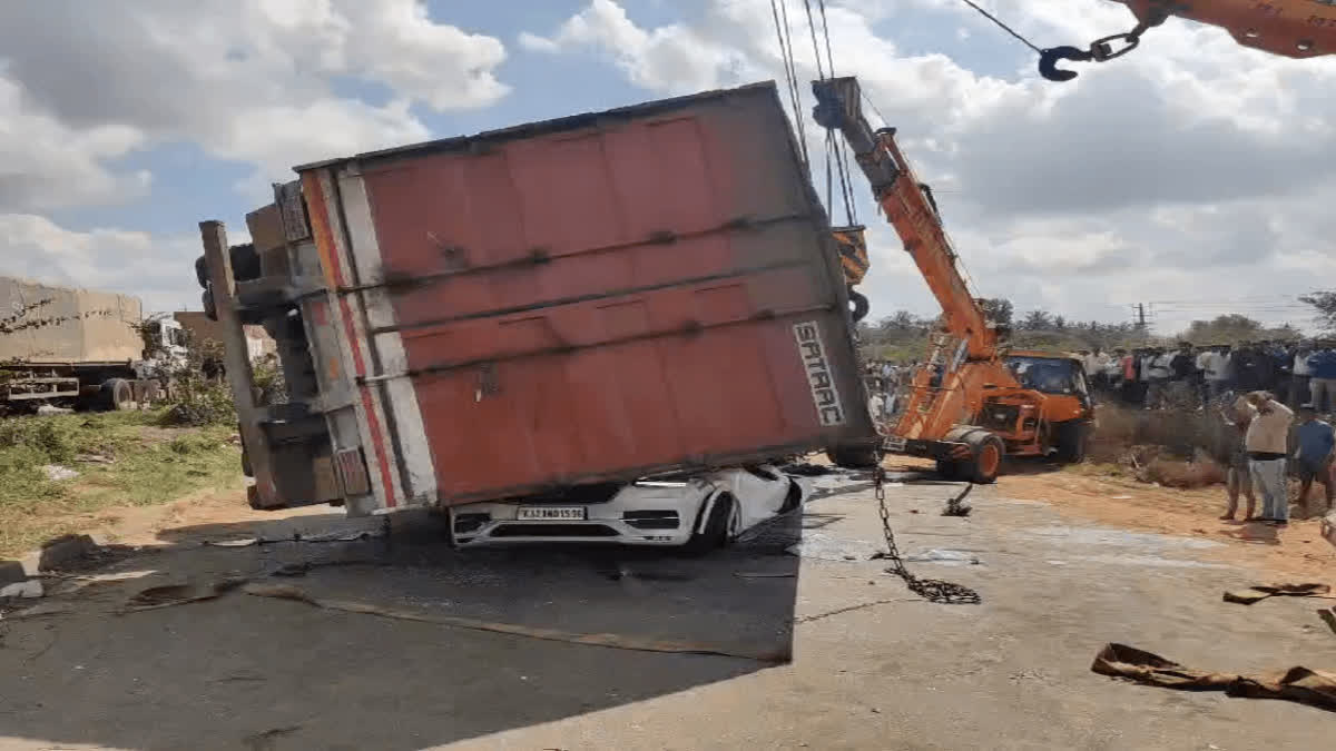 Container Truck overturns on car on Nelamangala National Highway In Karnataka on Saturday