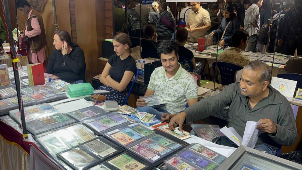 People looking at old notes at the Coin Festival.