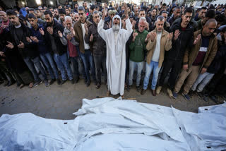 Palestinians pray over the bodies of the victims of an Israeli strike on a home late Saturday before the funeral outside the Al-Aqsa Martyrs Hospital in Deir al-Balah Sunday, Dec. 22, 2024.