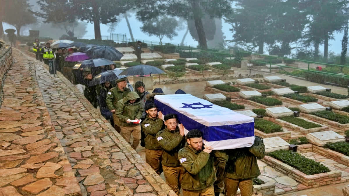 Israeli soldiers carry the flag-draped casket of reservist Elkana Vizel during his funeral at Mt. Herzl military cemetery in Jerusalem, Tuesday, Jan. 23, 2024. Vizel, 35, was killed during Israel's ground operation in the Gaza Strip, where the Israeli army has been battling Palestinian militants in the war ignited by Hamas' Oct. 7 attack into Israel. (AP Photo/Ohad Zwigenberg)