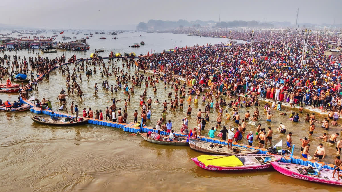 Devotees take a dip at Triveni Sangam during the ongoing Maha Kumbh 2025, in Prayagraj