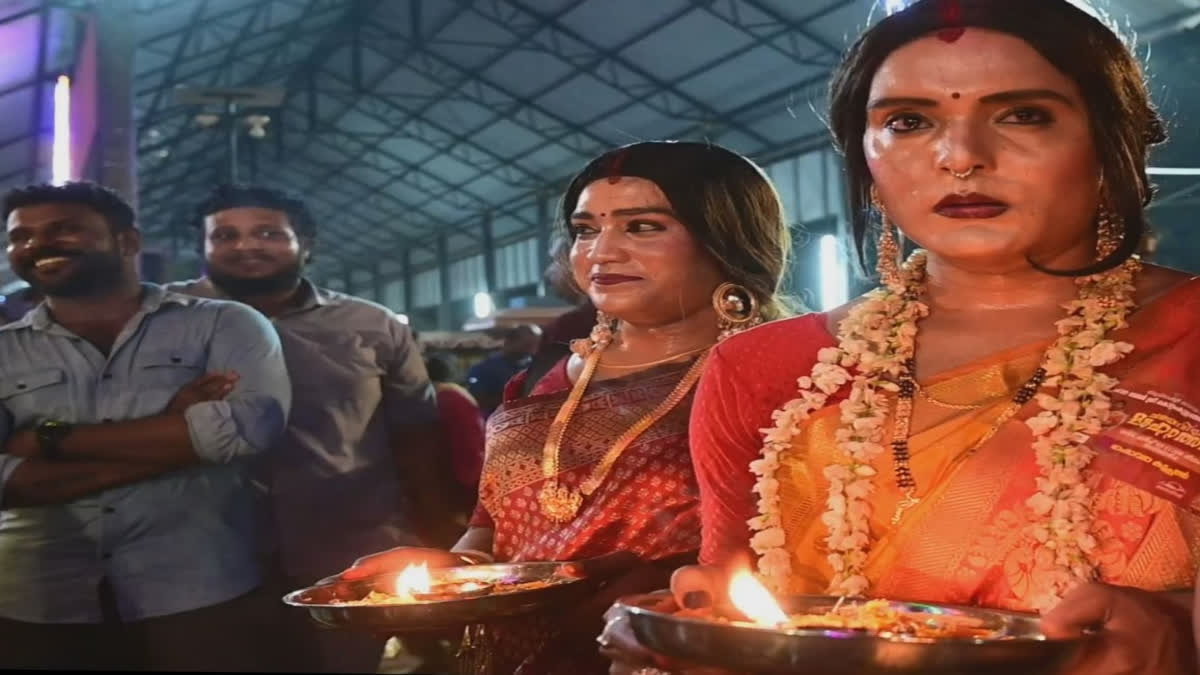 Men dressed like women offer prayers during Chamayavilakku in Kollam