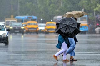மழையில் இருவர் குடையுடன் செல்லும் காட்சி