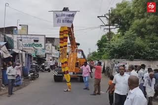 15 feet tall garland carried by crane