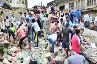 a two-storey dilapidated building collapsed in Gujarat's Junagadh city on Monday afternoon and four persons were feared trapped, officials said.