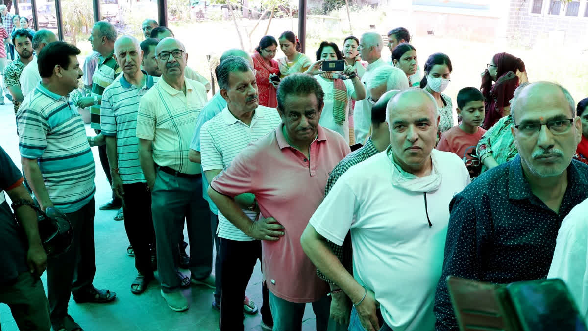 Kashmiri migrants stand in queue to cast their votes in Lok Sabha elections, at a special polling station, in Jammu on May 13, 2024.