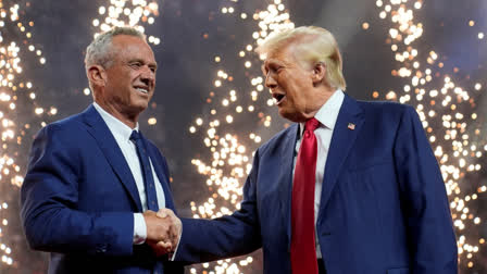 Republican presidential nominee former President Donald Trump shakes hands with Independent presidential candidate Robert F. Kennedy Jr. at a campaign rally at the Desert Diamond Arena, Friday, Aug. 23, 2024, in Glendale, Arizona.