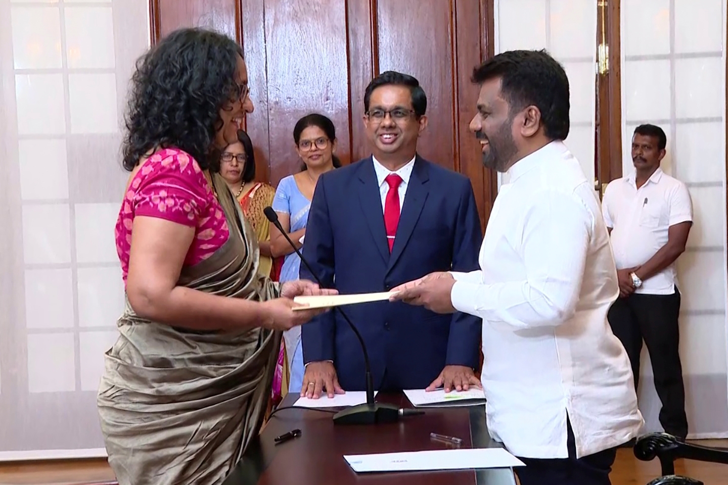 National People's power lawmaker Harini Amarasuriya, 54, left, takes oath for the post of Sri Lanka's Prime Minister in front of President Anura Kumara Dissanayake, in Colombo, Sri Lanka, Monday, September 23