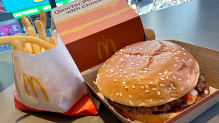 An E. coli outbreak linked to McDonald's Quarter Pounders has sickened about 50 people, with one fatality, likely from contaminated raw silvered onions.