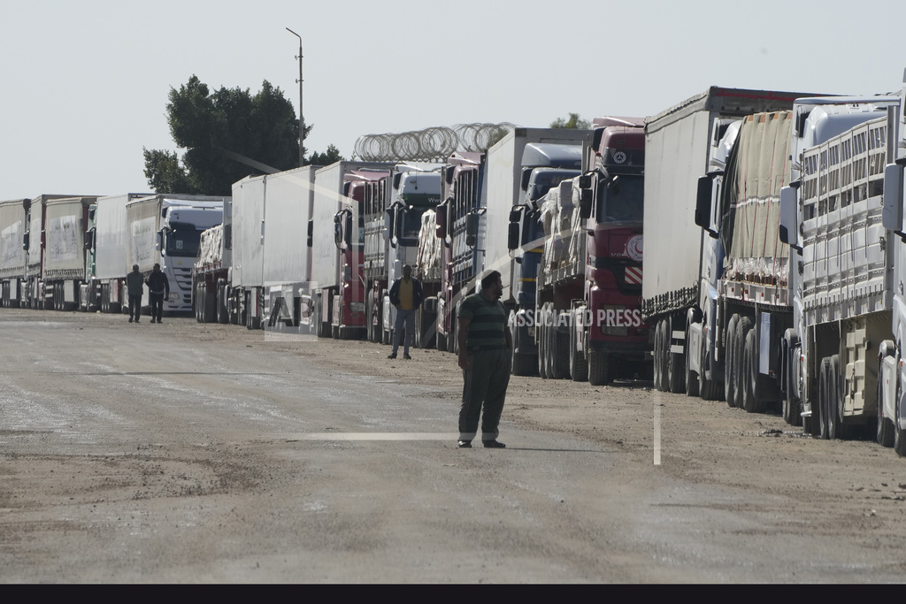 Trucks carying humanitarian aid line up in Rafah, Egypt