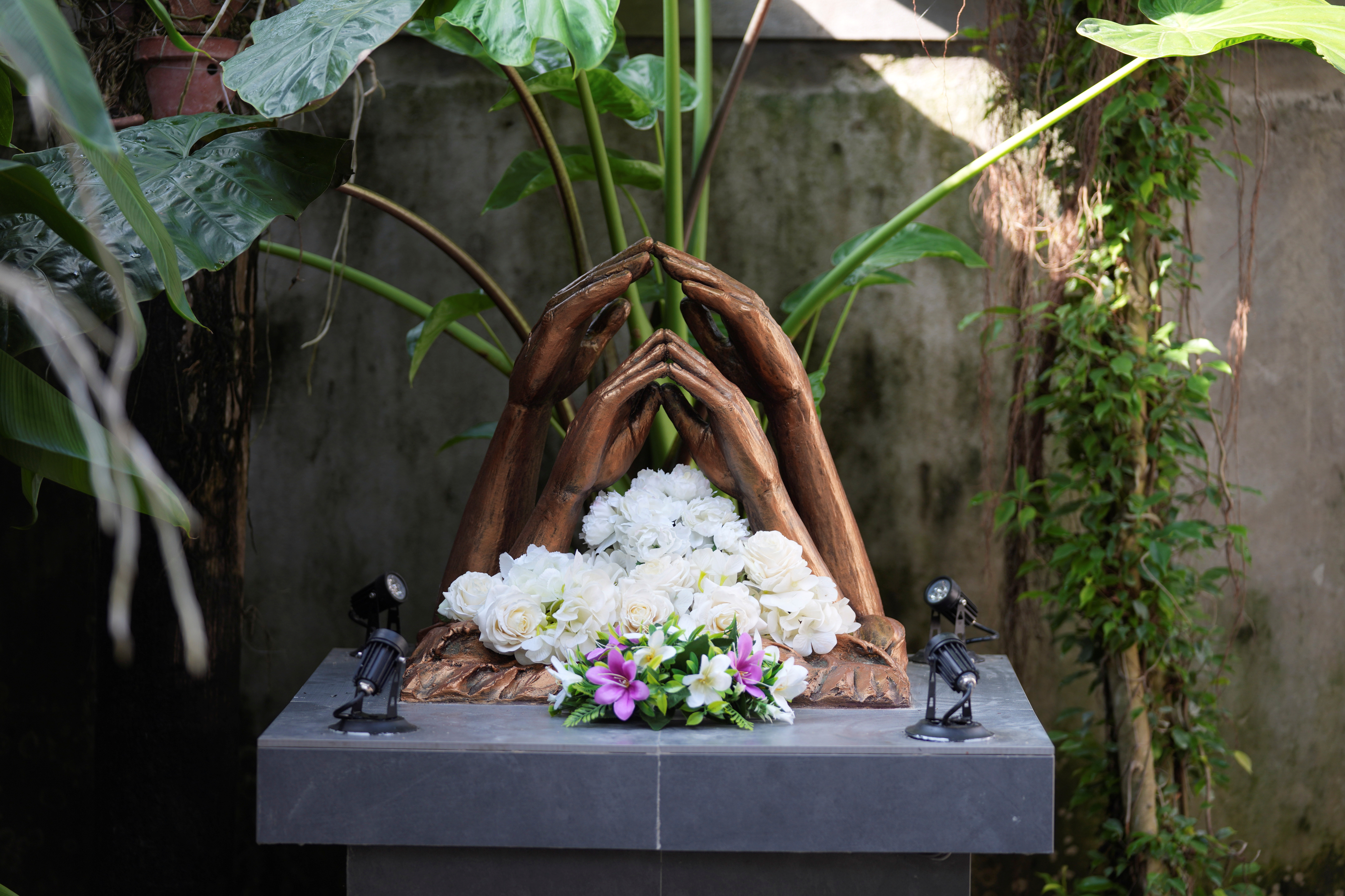 Floral tributes sit at a monument for the victims of 2004 Indian ocean tsunami at the residence of Jayarasa Abilash known as Baby 81 after he was swept away by the 2004 Indian ocean tsunami in Kurukkalmadam, Sri Lanka, Tuesday, Dec. 17, 2024.