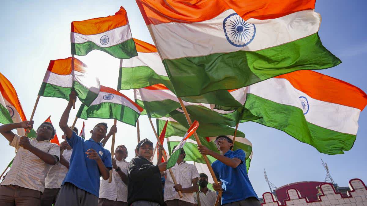 Students wave the national flags during full dress rehearsal for the Republic Day Parade in Bengaluru