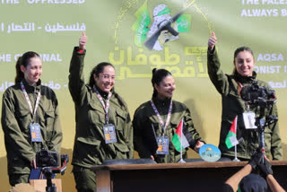 Israeli female soldier hostages wave and react at a Palestinian crowd before being handed over to the Red Cross in Gaza City, Saturday, Jan. 25, 2025.