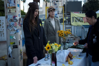 Relatives and supporters of hostages held by the Hamas militant group in the Gaza Strip mark the start of Shabbat in Tel Aviv, Israel, Friday, Jan. 24, 2025.