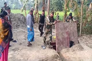 A BSF jawan opens the lid of an iron bunker