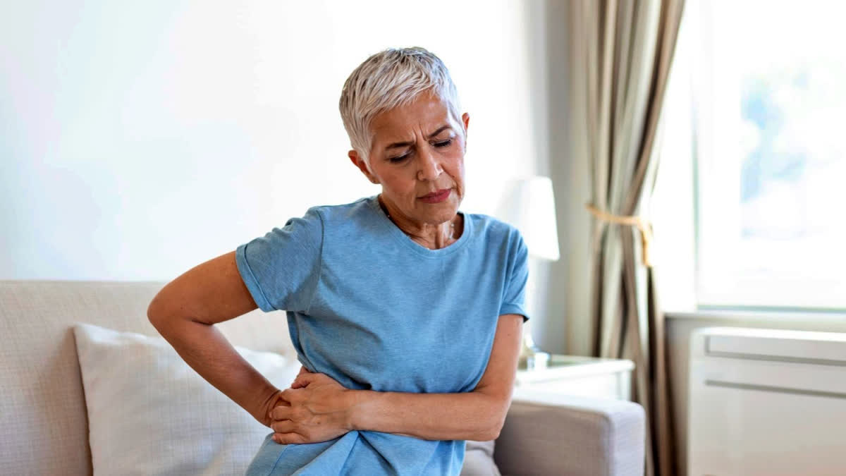 Woman experiencing pain in the kidneys