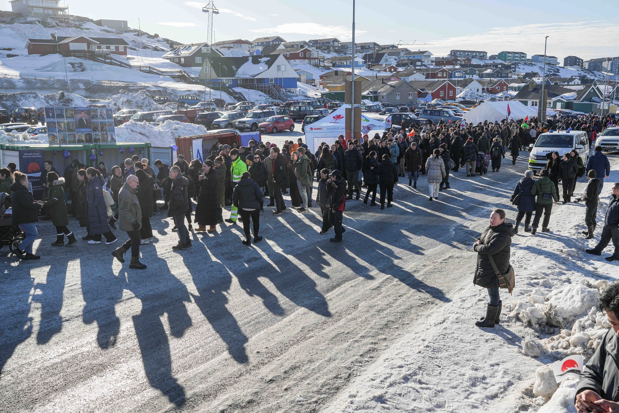 People stand in line outside a polling station to cast their vote in parliamentary elections, in Nuuk, Greenland, Tuesday, March 11, 2025.