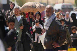 Displaced Palestinians, who flee from Rafah