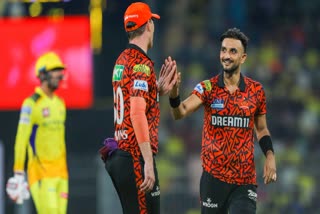 Harshal Patel celebrates taking a wicket with Pat Cummins