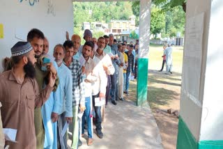Voters queue up outside a polling station to cast vote during the 6th phase of Lok Sabha election 2024 in Rajouri district of Jammu and Kashmir on Saturday May 25, 2024