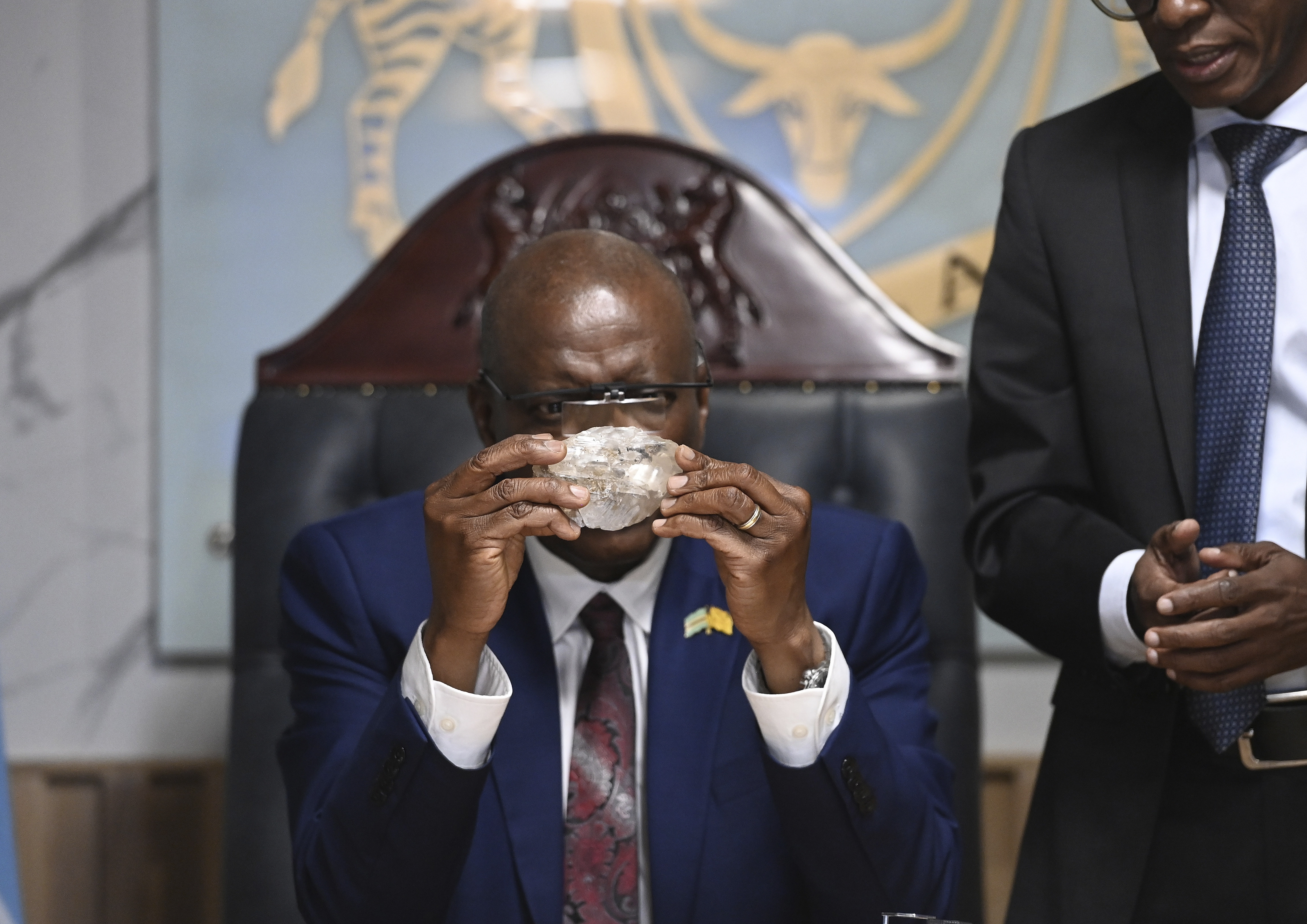 Botswana's President Mokgweetsi Masisi holds the Botswana Diamond