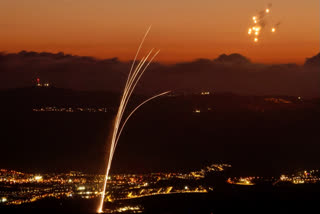 Rockets fired from southern Lebanon are intercepted by Israel's Iron Dome air defence system over the Upper Galilee region in northern Israel on August 23, 2024.