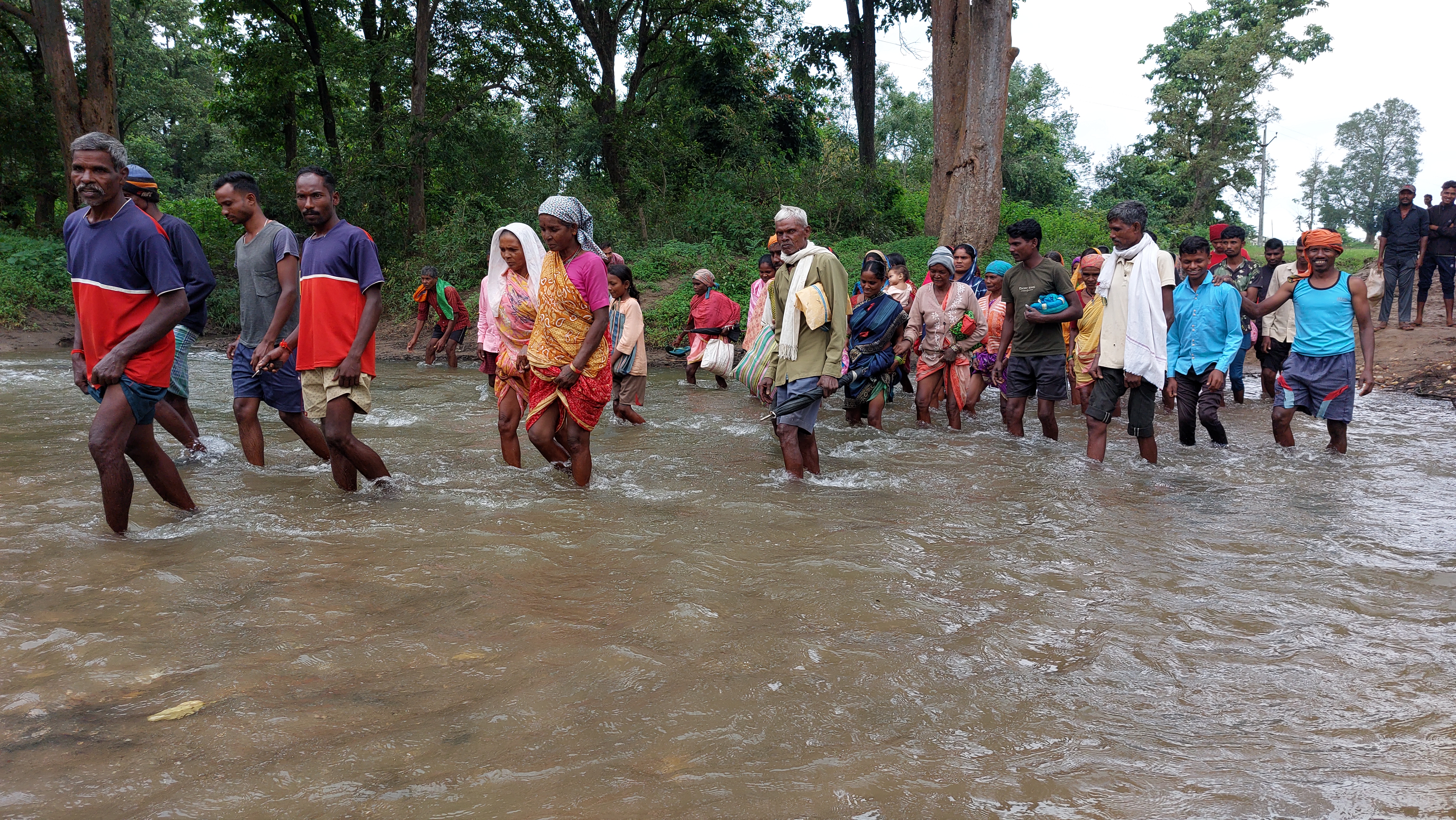 Villagers Carry woman on cot