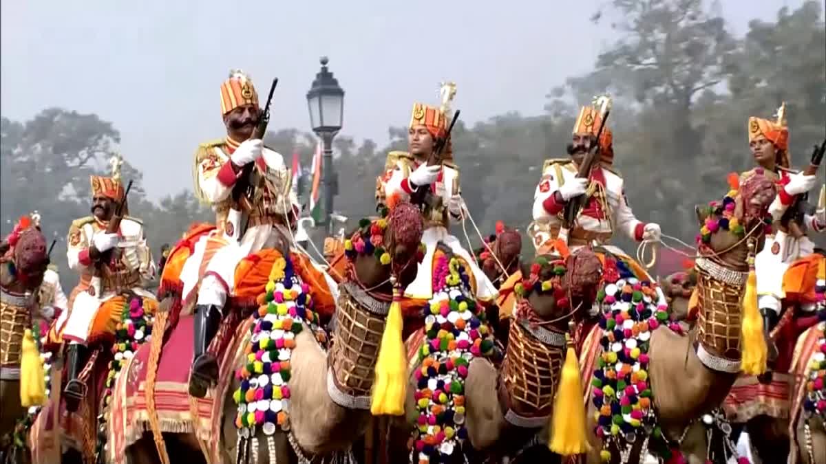 Female riders on decorated camels participate in R-Day parade