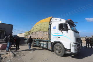 Humanitarian aid trucks enter the Gaza Strip from Israel through the Kerem Shalom crossing in Rafah on Sunday, Jan. 14, 2024. As the fighting rages on with no end in sight, the humanitarian catastrophe in the Gaza Strip has only worsened. United Nations agencies and aid groups say the ongoing hostilities, the Israeli military's refusal to facilitate deliveries and the breakdown of order inside Gaza make it increasingly difficult to bring vital aid to much of the coastal enclave. (Source- AP Photo/Hatem Ali)