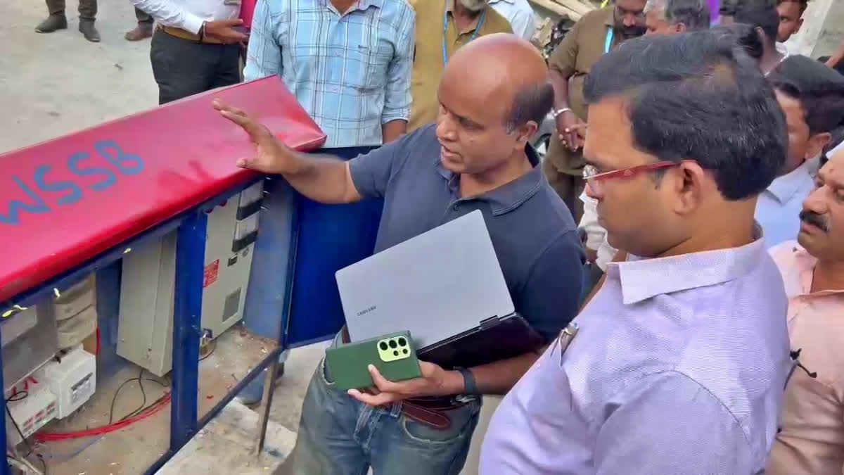 A senior official of the Karnataka Water Board inspects the trail run of a borewell installed with AI and IoT technology