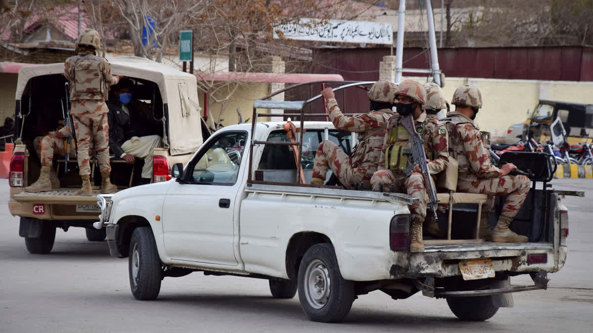 Pakistani soldiers arrive at the railway station to assist victims and survivors rescued by security forces