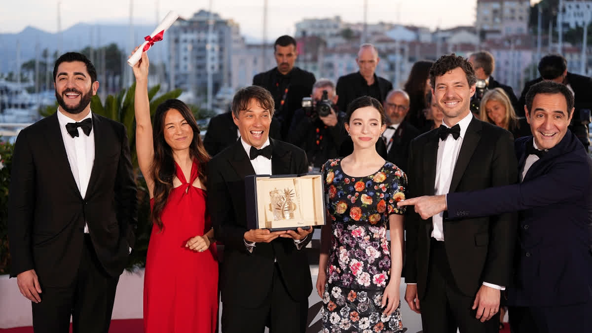 Sean Baker, third from left, winner of the Palme d'Or for the film Anora